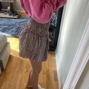 Trendig kjol med mänster!🌟 - Beige kjol med svart mönster. Shorts i som lätt kan tas bort om man vill använda den som en topp. Skicka för bild på.🩷 Nypris: ca 150 kr 
