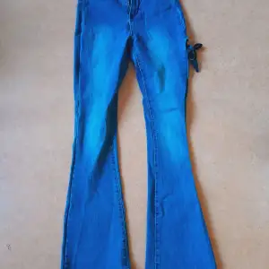 Ett par blåa jeans med stretch och en fin snörnings-detalj på baksidan av låret. Den visar inte så mycket hud men ger byxorna det där lilla extra. Storlek W27 L32, passar S och även M. De är från Shein och skicket är jättebra. 