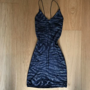 Glittrig tajt miniklänning - Jag säljer den här fina klänningen som är i jättebra skick då den aldrig kom till användning.