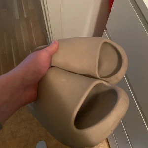 Yeezy Slides - Yeezy slides Köpta 2022-05-16, användes under sommaren 2022 men efter det har jag ej använt dem. Tillkommer med original sko låda. Storlek 44 1/2 men sitter som 43. 