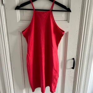 Figurnära miniklänning stl M NLY trend  - Figurnära miniklänning från NLY trend med hög halsringning. Fint skick. Stl M. Mjukt och skönt tyg! Något svårt att fånga färgen på bild, upplevs lite mer rosa i tonen än helröd :)  