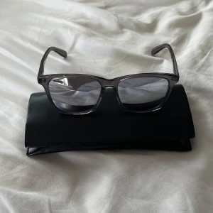 Saint Laurent SL 205/K  - Solglasögon från Saint Laurent i nyskick. Färgen är grå med rätt så reflektiva glas. Fodral medkommer. Hör av er ifall ni har frågor!