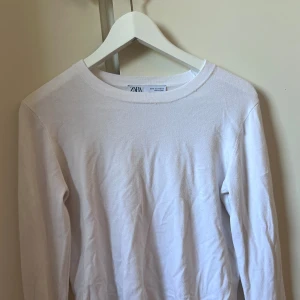 Vit tröja med guldiga knappar - Vit vanlig tröja med guldiga knappar längst ner på ärmarna 