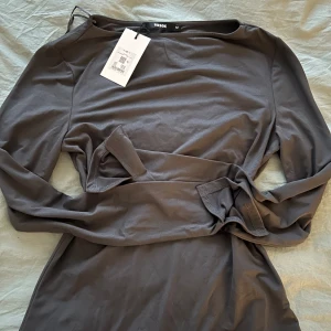 Bikbok tröja med slits - Säljer denna tröja med slits i ärmarna ifrån Bikbok i grå, säljs inte längre. Kan gå ner i pris i snabb affär. Prislapp finns kvar och ej andvänd😇💓