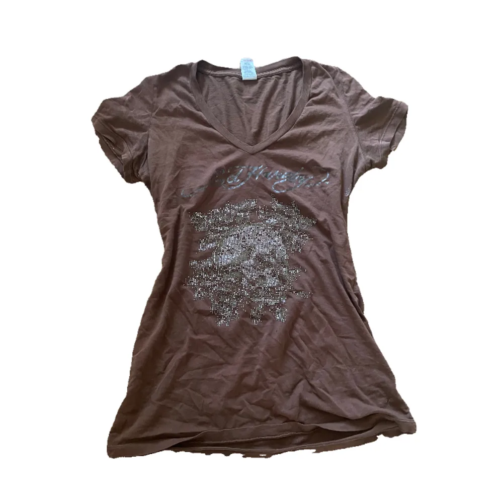 Ed Hardy top or dress in a brown color features rhinestones on the front and back. The Ed Hardy logo, also in rhinestones, is placed at the bottom back of the garment.  size M. T-shirts.