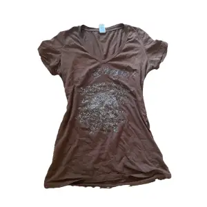 Ed Hardy top or dress in a brown color features rhinestones on the front and back. The Ed Hardy logo, also in rhinestones, is placed at the bottom back of the garment.  size M