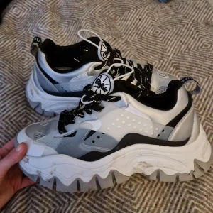 Chunky Buffalo sneakers strl 39 - Sparsamt använda Buffalo sneakers strl 39, något stora i storleken därav att jag tyvärr måste sälja dem! Silver och plast detaljer. Jätte sköna. Tror jag betalade 1300 kr för dem.