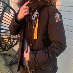 Parajumpers jacka  - Dragkedjan har fastnat men den går att stänga med knapparna om man inte vill laga den. Använd en del därav priset. Högt inköpspris. Mycket fickor och varm jacka. 