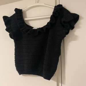 stickad oanvänd topp med volanger  - En stickad topp från H&M som är helt oanvänd. Fina volanger och fint matrial