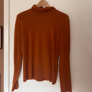 Mjuk, tunn polotröja  - En orange-brun, mjuk, tunn, polotröja. Fint skick 💓 stl L men är väldigt stretchig.