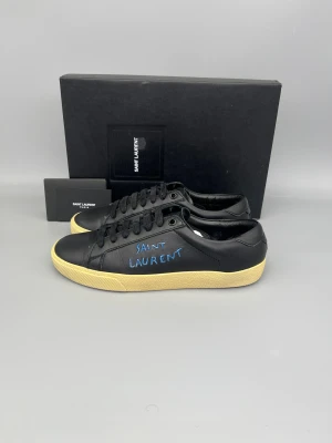 Saint Laurent SL/06 Sneaker - • The shoes have been gently used and are in really good condition  • Size: 37.5 (fits 38–38.5)  • Color: Black  • Retail price: 7200 SEK / 650€  • Box, SL card & saint laurent booklet included
