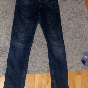 Mörkblå Acne Studios Ace Oreo jeans - Säljer ett par mörkblå jeans från Acne Studios, modell Ace Oreo. Klassisk femficksdesign med raka ben och normal passform. Materialet är en mix av bomull, lyocell och elastan för skön stretch. Perfekt för dig som gillar stilrena och tidlösa jeans.