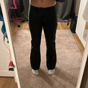 Svarta bootcut byxor från Madlady - Snygga svarta byxor från Madlady i bootcut-modell. De har låg/medelhög midja, dragkedja och knappstängning framtill. Innerbenslängden är 79cm. Inte jättestretchiga, men mycket sköna och perfekta byxor nu till hösten!
