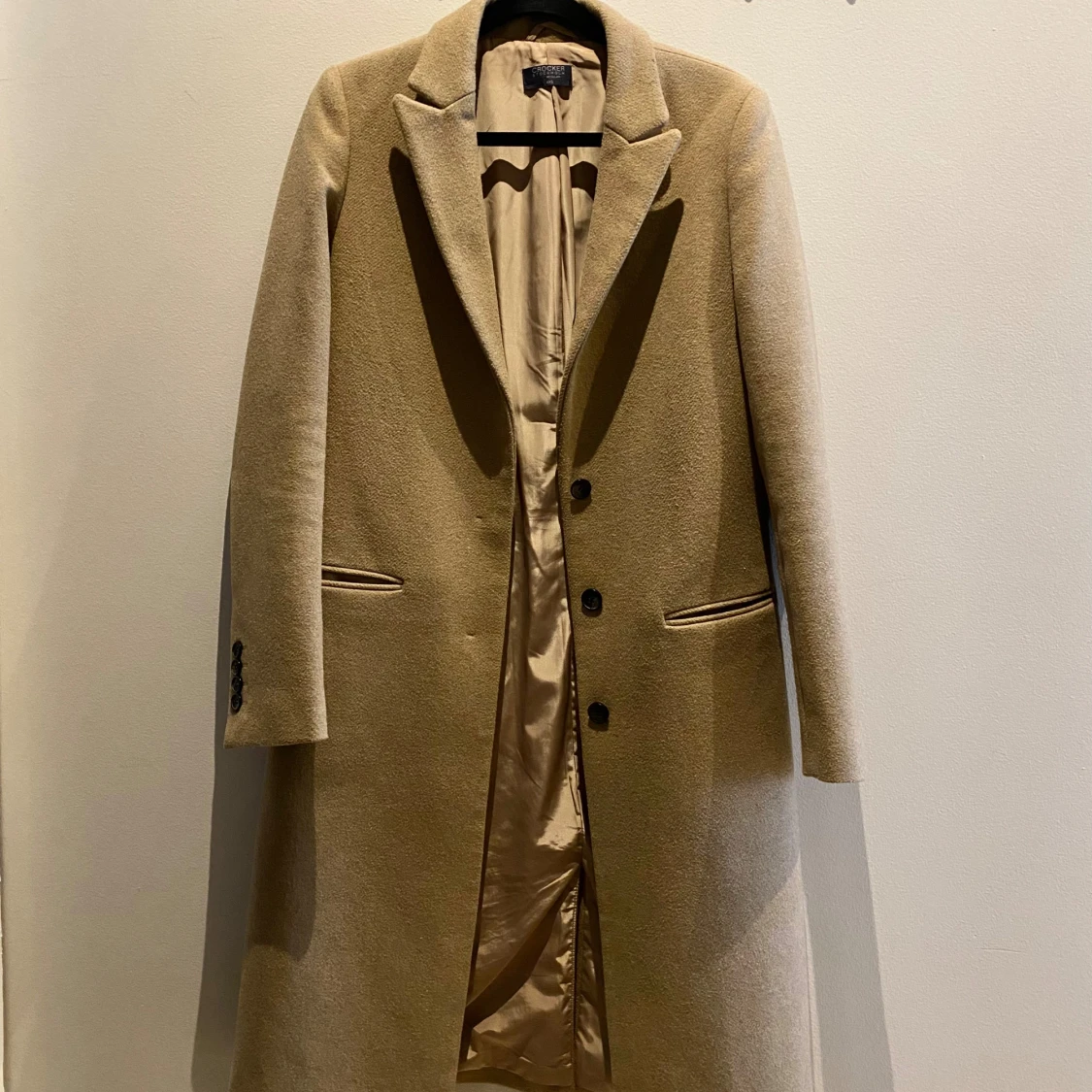 Beige kappa från Crocker