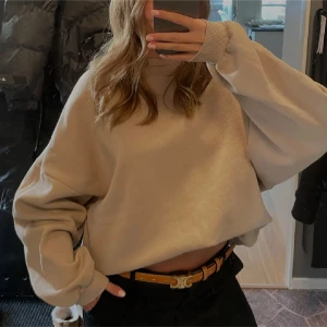 Beige oversized sweatshirt - Säljer en beige oversized sweatshirt med långa ärmar och ribbade muddar. Tröjan har en avslappnad passform och är perfekt för en chill och trendig look. Passar till både jeans och leggings.