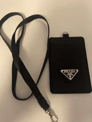 Svart plånbok med en axelrem - Säljer en helt ny plånbok med en axelrem helt ny inte använd en ända gång 