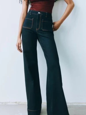 Svarta wide jeans med hög midja - Snygga svarta jeans med hög midja och breda ben. Jeansen har framfickor med kontrastsömmar och klassisk knappstängning. Perfekta för dig som gillar en trendig och avslappnad look.