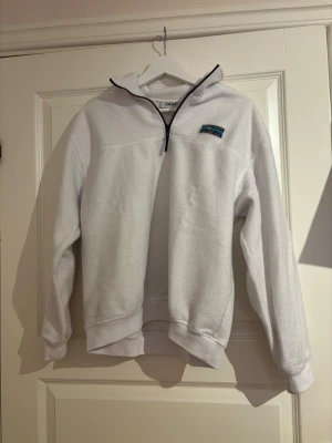 Vit fleece-tröja från Junkyard - En snygg fleece-tröja med halv-zip. Tröjan är från Junkyard med märket Urban Tears och är i storlek Xs. Ursprungspris ca 699kr. 