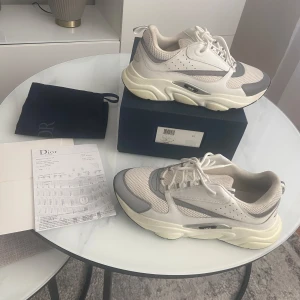Dior b22 Vita  - Säljer ett par dior b22 skor, använd fåtal gånger och i bra skick med box påse och kvitto. Priset kan diskuteras !!!