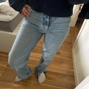 Ljusblå raka jeans med hög midja - Säljer ett par ljusblå jeans med hög midja och raka ben. Jeansen har klassisk femficksdesign och stängs med knapp och dragkedja. De är tillverkade i jeansmaterial och har en avslappnad, lite loose passform som ger en chill vibe.