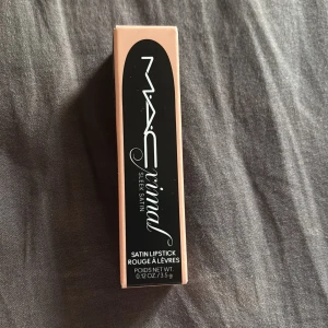 MAC Satin Lipstick Creme D'Nude - MAC Satin Lipstick i nyansen 833 Creme D'Nude. Ett krämigt läppstift med satin-finish i en nude/ljusbeige ton. Kommer i klassisk svart MAC-hylsa med silverdetalj. Perfekt för dig som gillar en naturlig look. Endast testad. Köpt för 350kr