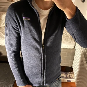 Mörkblå Patagonia fleece - Säljer en mörkblå fleecekofta från Patagonia. Den är i väldigt bra skick. Passar bäst på någon som är 160- 170cm 45-60kg. Säger inte i säkerhet att det passar men bara på ett ungefär. Vid tanke är det bara att ställa fråga!