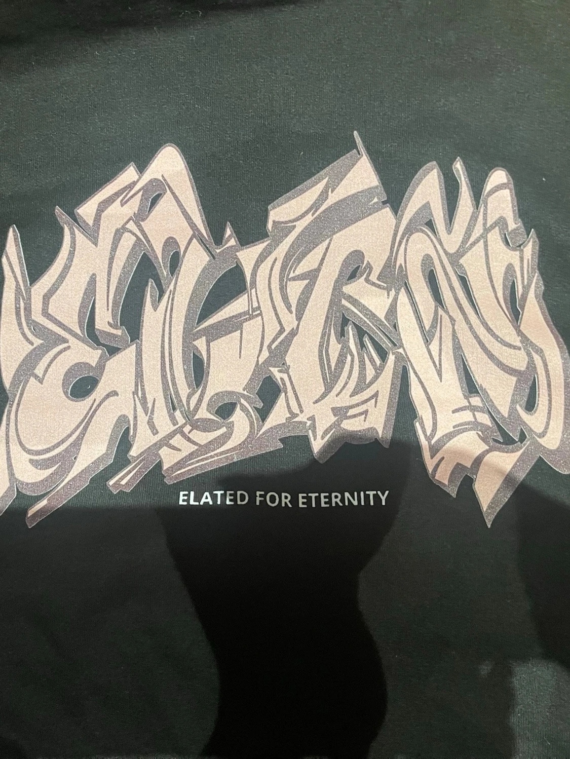 This is a black hoodie with graphic  - 2