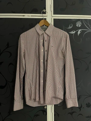 Tommy Hilfiger Randig Skjorta - Randig skjorta från Tommy Hilfiger som är i mycket fint skick. Storlek M