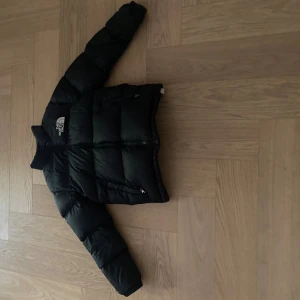 Svart pufferjacka från The North Face - Säljer en svart pufferjacket från north face i storlek xs. Den har ett litet hål på ena armen som jag har täckt över med svart specia tejp så det knappt syns. Har också gått ner i pris pågrund av det, jackan kostar runt 3000 ny. Skriv vid minsta fundering🤗