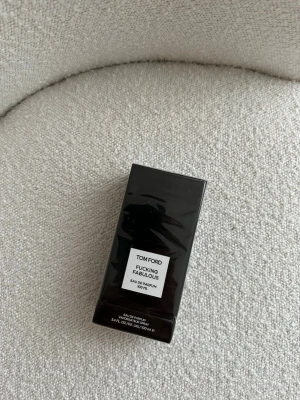 Tom Ford Fucking Fabulous parfym 100 ml - Exklusiv parfym från Tom Ford, Fucking Fabulous, i en elegant svart rektangulär flaska med vit etikett. Flaskan rymmer 100 ml Eau de Parfum och har en lyxig och modern design som sticker ut i badrumshyllan.