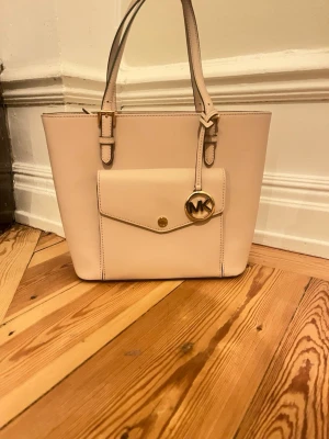 Rosa handväska från Michael Kors - Jättefin väska från Michael Kors i  ljus rosa färg använd några gånger men i bra skick