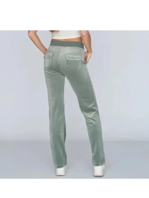 Gröna Juicy byxor - Mysiga gröna mjukisbyxor i velour med bred resårmidja och snörning. Byxorna har raka ben, fickor både fram och bak samt en relaxed passform. Perfekta för chill dagar eller när du vill vara extra bekväm.