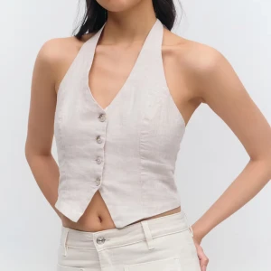 VIT linnetopp med knyt och knappar - Säljer en VIT (se bild 2 och 4, hittar ej den vita på hemsidan) linnetopp med halterneck och knyt i nacken . Toppen har v-ringning, dekorativa knappar framtill och croppad passform. Tillverkad i linne för en luftig känsla, perfekt för varma dagar. Snyggt figursydd och lätt att matcha med jeans eller kjol.