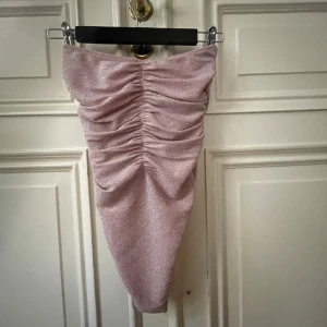 Glittrig ljusrosa bandå-body - Super snygg ljusrosa glittrig body, aldrig använd! Den har ett stretchigt material så den passa alla från xxs-m! Köp nu jag postar snabbt!!💓💓