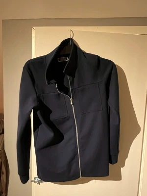 Snygg overshirt från Jack and Jones  - En snygg overshirt i marinblått från Jack and Jones. I storlek 164-170 men sitter som en xs! Snygg att ha nu till kommande festligheter i vinter. 