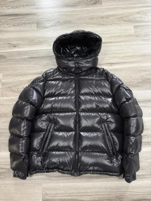 Svart Moncler jacka bytes - Säljer en svart, glansig pufferjacka från Moncler med stor huva och två snedställda fickor med dragkedja. Jackan har quiltad design och klassisk Moncler-logga på insidan bytes mot nå skoj 🤌 skor , smycken , kläder ja kom med förslag 