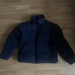 The North Face Sherpa Nuptse Jacka - Säljer en supermysig marinblå dunjacka från The North Face. Den är perfekt för kalla dagar med sitt fluffiga material och quiltade insida.❄️ Jackan har en dragkedja framtill och är långärmad. Använd fåtal gånger då den växtes ur✨ Nypris: 3400