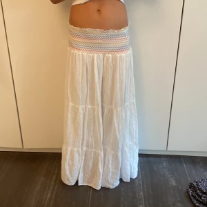 Vit långkjol med färgglad midja - Säljer en superfin vit långkjol med en färgglad, mönstrad midja. Nästan helt oanvänd och inga defekter!💞💞