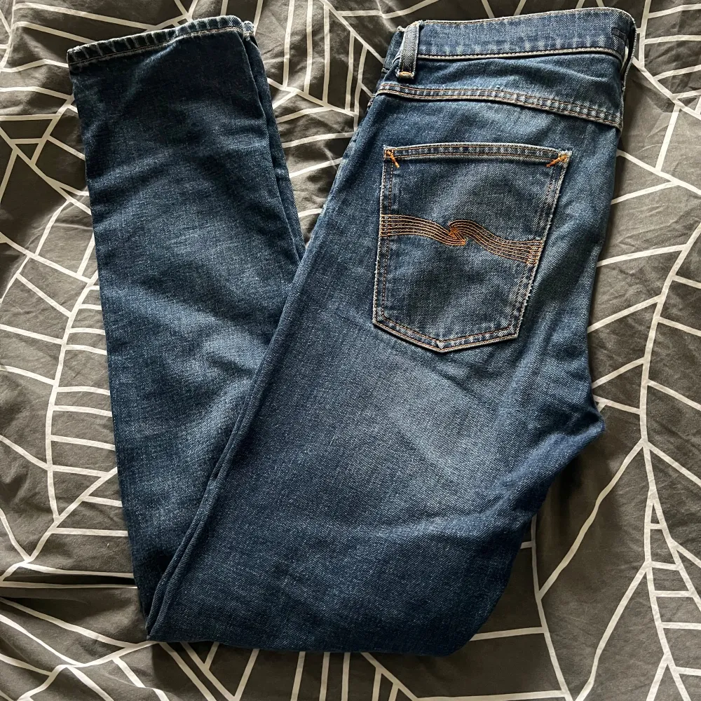 Ett par riktigt feta nudie jeans i storleken 31/32, de har lite slitage på högra låret som man kan se på bilden. Samt är de lagade vid bakre fickorna som man också kan se på bilden. Men de är i mycket gott skick utövar slitaget på högra låret. Jeans & Byxor.