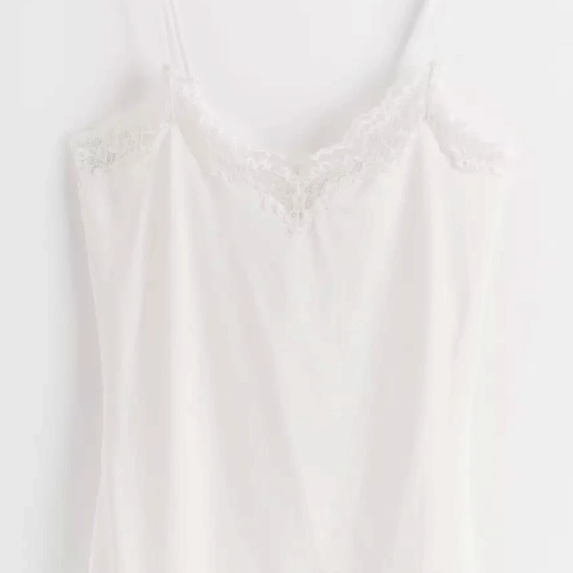 Vit linnetopp med spetsdetaljer från Lindex