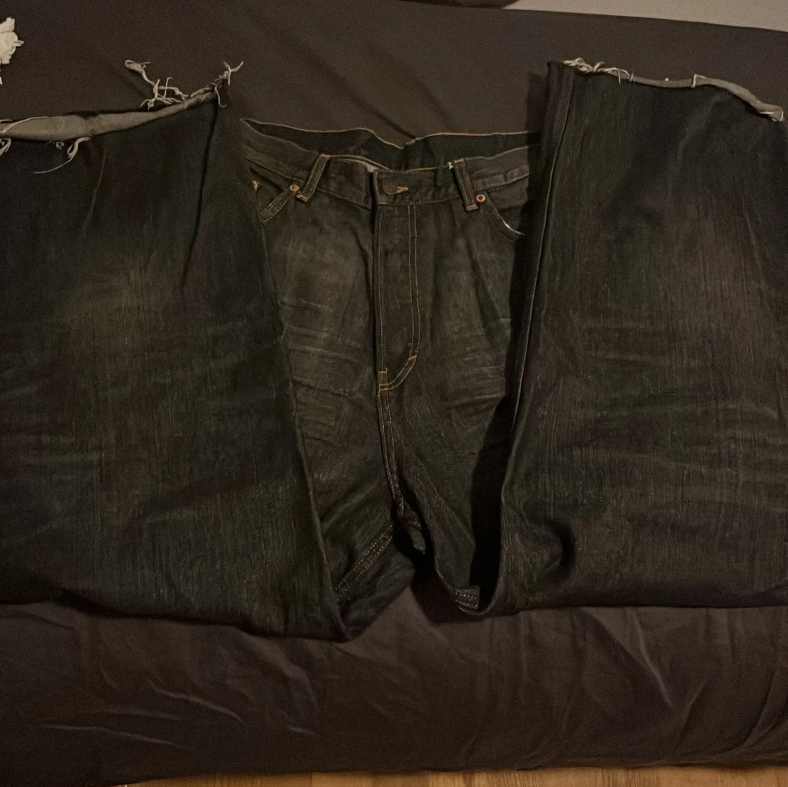 Svarta jeans med slitna detaljer