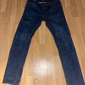 Mörkblå jeansbyxor - Säljer ett par snygga mörkblå jeansbyxor i bra skick. De har en klassisk straight passform och är perfekta för både vardag och fest. Perfekta för höst och vår!stl 30x32
