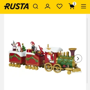 Julinspirerat tåg för julgran - Detta charmiga julinspirerade tåg från Rusta är den perfekta dekorationen för att placeras runt julgranen. Tåget är rött och grönt med detaljer i guld och har små tomtar och julklappar som passagerare. Det ger en mysig och festlig känsla till ditt hem under julen.  (Oanvänd pga den var för stor under våran gran)