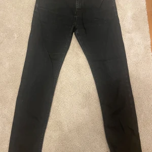 Svarta jeans från Zara Man - Säljer ett par svarta jeans från Zara Man i bra skick. De har en slim passform och är perfekta för både vardag och fest. Klassisk design med knapp och dragkedja framtill. Passar till alla säsonger och är ett måste i garderoben!