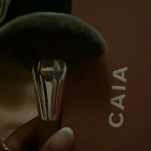 Sminkborste från CAIA - Säljer en supermjuk och fluffig sminkborste från CAIA, modell F02. Perfekt för att applicera puder eller bronzer jämnt över ansiktet. Borsten har ett elegant handtag i metall och trä💞💞💞