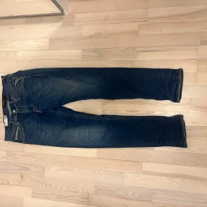 Blå jeansbyxor från Replay - Snygga blå jeansbyxor från Replay, modell Grover. De har en straight fit och klassisk design med fem fickor och knappgylf. Perfekta för en avslappnad stil. Modellen är grövre som är en fin Modell med slim fit