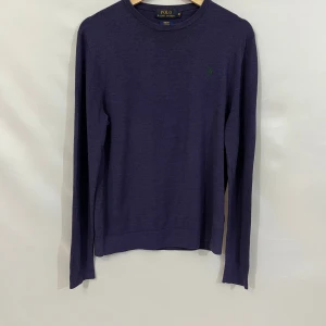 Ralph lauren stickad merino wool lila - En jättefin merino-ull längärmad tröja frän ralph lauren. Den är i jättebra skick men nack-taggen är lite missfärgad (se bild). Storlek: M.