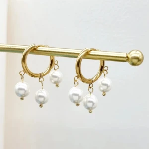Guldörhängen med pärlor - Eleganta guldörhängen med tre vita pärlor som hänger från varje ring. Perfekta för att ge en touch av klass och stil till din look.Handgjorda örhängen ● 💎Material- 100% rostfritt stål och pärlor ●Längd -3,5cm Handgjorda örhängen ● Vattentåliga, ändrar inte färgen! 