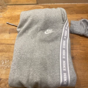 En grå Nike tracksuit i storlek S. - Tracksuiten är i bra skick, inga synliga fel med den. Säljer den eftersom den är för stor