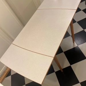 Fint Perstorpsbord design Sigvard Bernadotte - Designern Sigvard Bernadottes klassiker ”virrvarr”.  Retrobord med utdragbar skiva i vit laminat och ben i ljus trä i fint vintageskick.  Perfekt som extra bord eller till mindre kök. En charmig detalj till hemmet med en retrokänsla.  Längd 80/ 137 Bredd 70 Höjd 74   Kan levereras i närheten av Nacka (Stockholm).  Benen går att skriva loss